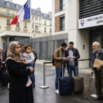 An editorial photo documenting the recent France immigration system changes outside a prefecture building in Paris.